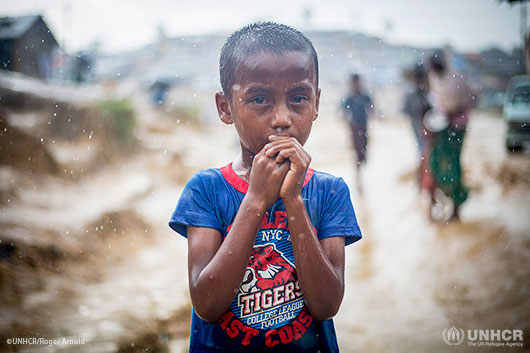 A Rohingya boy stands in the rain at Kutupalong refugee camp in Cox's Bazar, Bangladesh.