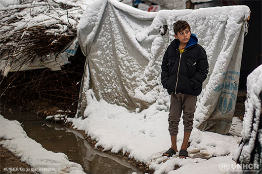 A young refugee stands outside his home inside an informal settlement camp in Bekaa Valley.