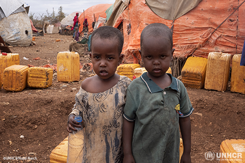 Two displaced Somalian children look into the camera