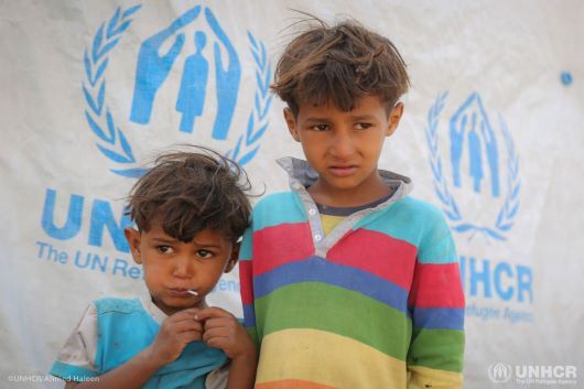 Two displaced Yemeni brothers live with their mother and father, Hashim, at a hosting site in Sana'a.