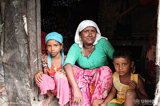 Makhin Nu, 45, sits in front of her makeshift shelter with her two grandchildren (Hla Hla Myint, 9 and Mustakmima, 5) in Say Tha Mar Gyi, a displacement camp home to some 16,500 Rohingya internally displaced people in Rakhine State, Myanmar.